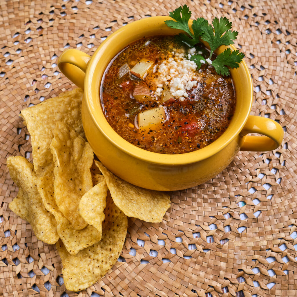 Caldo De Queso in  a bowl with taco chips on the side
